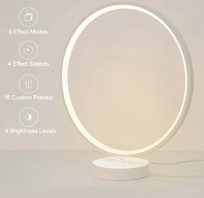 AUKEY Circular RGB Table Lamp is emitting white light on desk.